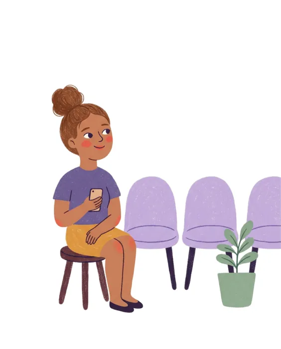 A woman sitting in a waiting room holding her phone